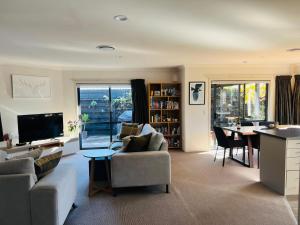 a living room with a couch and a table at Convenient in Cambridge in Cambridge
