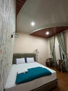 ein Schlafzimmer mit einem großen Bett in einem Zimmer in der Unterkunft Sapo Rumbia Homestay in Berastagi