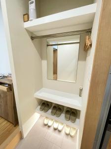 a bathroom with white shelves and a mirror at ETSU 悦 HOTEL Chuo Ward Tokyo 1-2BDR House in Tokyo +71 photos