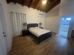 a bedroom with a bed and a wooden floor at Itopia in Gros Islet