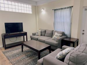a living room with a couch and a flat screen tv at Itopia in Gros Islet