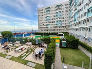 an overhead view of a building with people sitting in a courtyard at Dumaguete Marina Spatial Condo Unit in Dumaguete