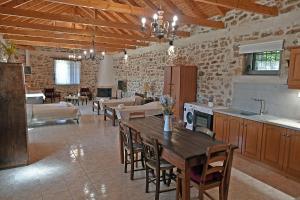 a large kitchen with a table and a living room at Gamvrias chalet in Gamvriá