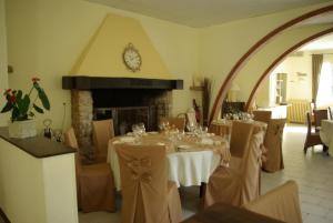 a dining room with a table and a fireplace at Auberge Du Parc in Orgon