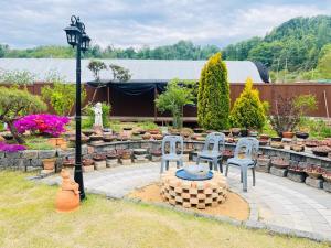 a group of chairs and a table in a garden at Sarah's Small Garden in Cheonan