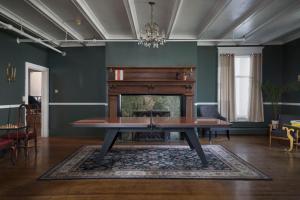 a living room with a table and a fireplace at The Revival House in Adams