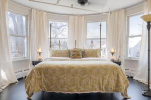 a bedroom with a large bed with windows at The Revival House in Adams