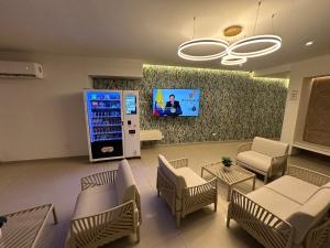 a waiting room with chairs and a video screen at Oasis Hotel in San Andrés