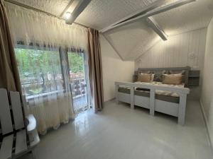 a room with a bed and a large window at Гостинний двір in Yaremche +46 photos