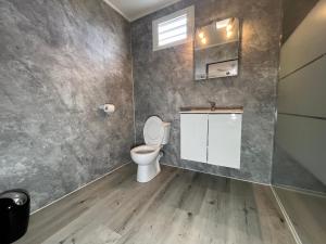 a bathroom with a toilet and a sink at Les Bungalows du Sud 1 in Saint-Pierre