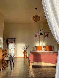 a bedroom with a bed and a table and a chair at ViewNaaBaan At Phamee in Ban Pha Mi