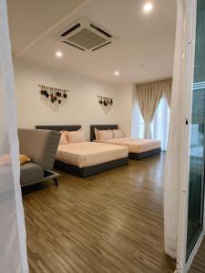 a living room with two beds and a couch at Setapak Central KL - Zetapark Zen Suites in Kuala Lumpur +24 photos