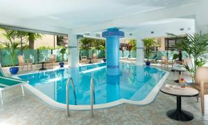 a pool with a slide in a hotel at Hotel Gabbiano in Cattolica