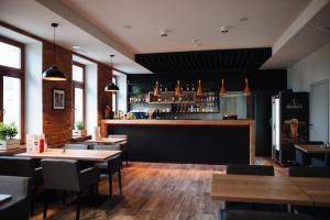 a dining room with tables and a bar at Fresco Hostel in Suwałki