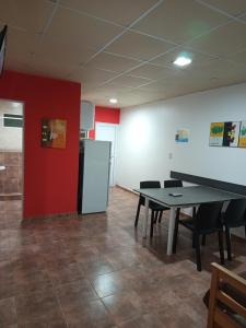 a room with a table and chairs and a refrigerator at Las Casuarinas in Federación