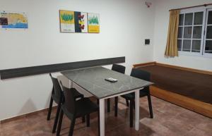a dining room with a table and chairs at Las Casuarinas in Federación