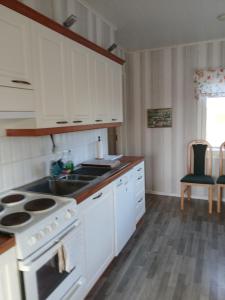 a kitchen with a stove and a sink at Detached house with everything you need in Dagsmark