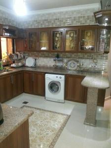 a kitchen with a washer and dryer in it at Z apartment in Az Zarqa