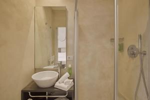 a bathroom with a sink and a shower at Hotel Le Mura in Lazise