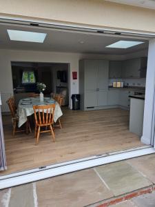 a kitchen and dining room with a table and chairs at Inner cottage in Brent Knoll