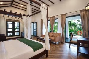 a bedroom with a bed and a desk and a couch at Reen Resorts Aanavilasam Plantation Thekkady in Thekkady +176 photos