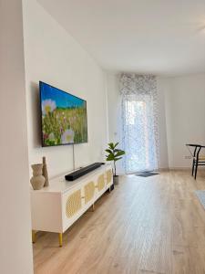 a living room with a tv on a white wall at Perfect for fans and travelers in Gelsenkirchen