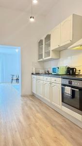 a kitchen with white cabinets and a stove top oven at Perfect for fans and travelers in Gelsenkirchen