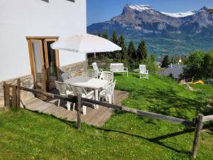 a table and chairs with an umbrella on a hill at Bethel-Mont-Blanc in Saint-Gervais-les-Bains +13 photos