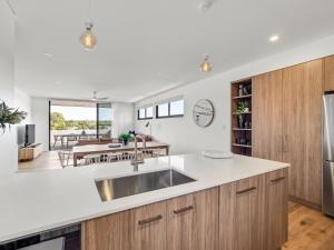 a kitchen with a sink and a dining room at Margaret's Luxe Penthouse - exclusive retreat! in Margaret River Town
