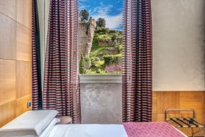 Postel nebo postele na pokoji v ubytování Kolbe Hotel Rome
