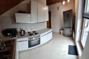 a small kitchen with a stove and a refrigerator at Vacation Rental Good Times in Friedberg