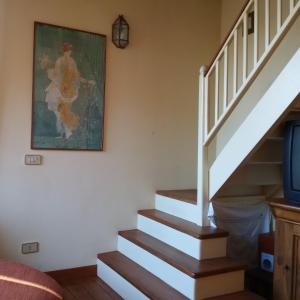 a staircase in a house with a painting on the wall at B&B Tra Mare e Laguna in Venice-Lido