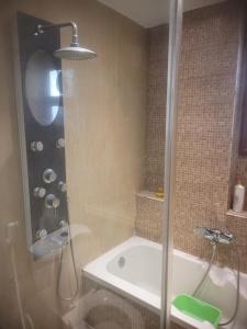 a bathroom with a shower and a bath tub at CozyHome 2BR Place New Cairo with Private Garden in Cairo +14 photos