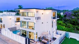 an aerial view of a large white house at Emquatier Pool Villa Pattaya in Ban Huai Yai