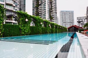 a swimming pool in a city with tall buildings at M Social Hotel Singapore in Singapore