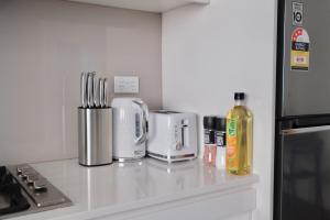 una encimera de cocina con varios electrodomésticos en Super Convenient 1BR Apt Free Parking & study, en Sídney 7 fotos más