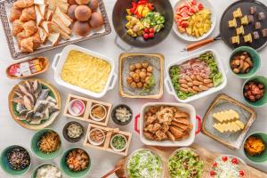 a table with many different dishes of food on it at Via Inn Nagoya Station Tsubaki-cho in Nagoya
