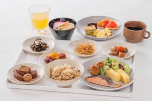 a tray filled with plates of food on a table at Via Inn Nagoya Station Tsubaki-cho in Nagoya