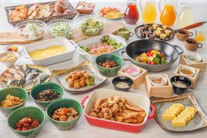 a table with many different dishes of food at Via Inn Nagoya Station Tsubaki-cho in Nagoya