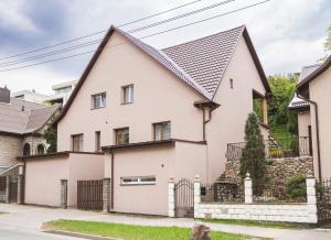une maison blanche avec un toit noir dans l'établissement Chill&Go Apartment, à Kaunas