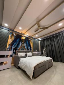a bedroom with a large bed and a painting on the wall at Studio z leisure stay in Lucknow