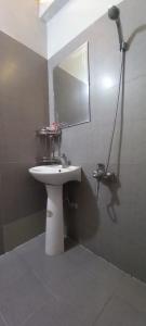 a bathroom with a white sink and a mirror at Cha Ta Homestay & Trekking Tour Sa Pa in Sa Pa