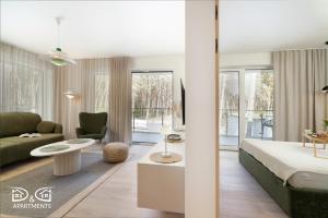 a bedroom with a bed and a living room at Apartament Zielony D&D APARTMENTS in Międzywodzie