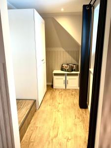 a small room with a white cabinet and wood floors at Smöögsch Lagune Büsum in Büsum