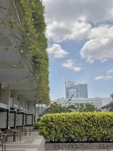 a view of a building with benches and buildings at The Intramuros Suite in Manila +26 photos