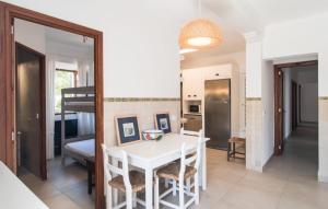 a kitchen and dining room with a white table and chairs at Villa Cabrera in Colonia Sant Jordi