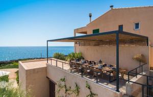 a table on the side of a building with the ocean at Villa Cabrera in Colonia Sant Jordi