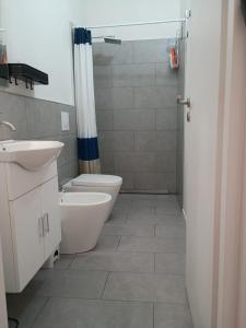 a bathroom with a toilet and a sink and a shower at Mamè Guest House in Figlino +14 photos