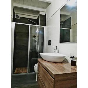 a bathroom with a sink and a toilet and a shower at Nina casa vacanze in Leverano