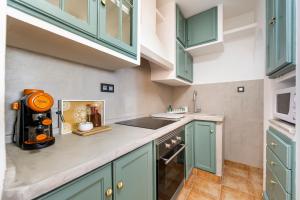 a kitchen with green cabinets and a sink at Apartamento Loli in Aguadulce +13 photos